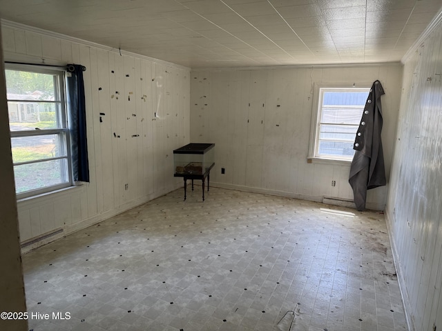1207 Harrington St, Washington, NC 27889 - empty room featuring healthy amount of natural light, ornamental molding, wooden walls, and baseboards