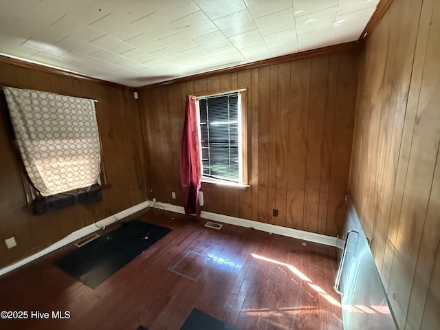 1207 Harrington St, Washington, NC 27889 - empty room with baseboards, wood finished floors, and wooden walls