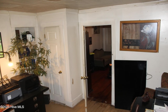 home office featuring light wood-style floors and ornamental molding