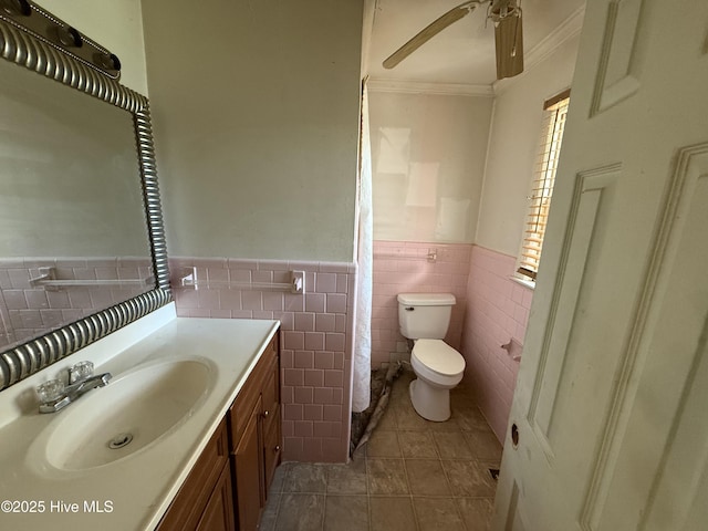1207 Harrington St, Washington, NC 27889 - full bathroom featuring a wainscoted wall, toilet, vanity, tile patterned flooring, and ceiling fan