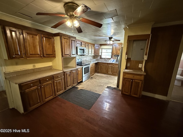 1207 Harrington St, Washington, NC 27889 - kitchen featuring stainless steel appliances, a ceiling fan, light countertops, ornamental molding, and a sink