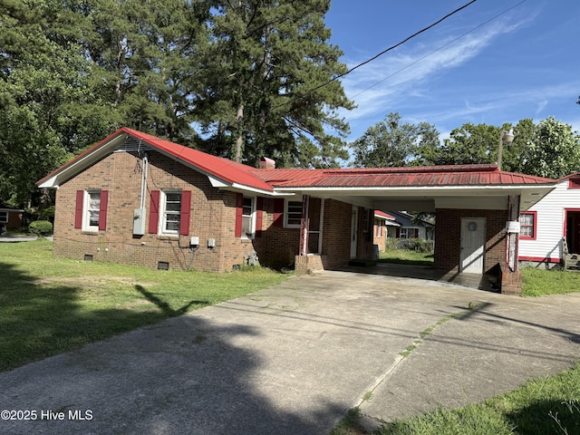 1207 Harrington St, Washington, NC 27889 - ranch-style house with crawl space, concrete driveway, a front lawn, and brick siding