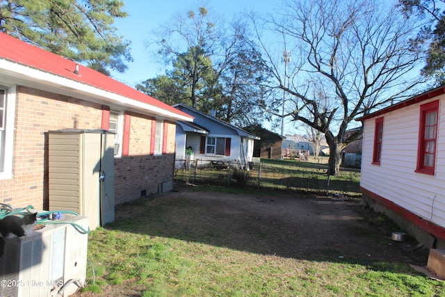 view of yard featuring fence and cooling unit