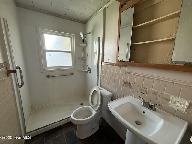 1207 Harrington St, Washington, NC 27889 - full bath featuring a sink, a shower stall, toilet, tile walls, and tile patterned flooring