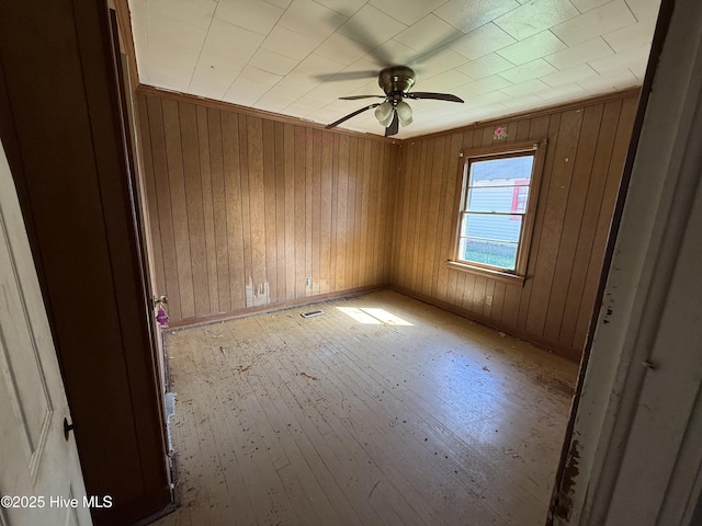 1207 Harrington St, Washington, NC 27889 - unfurnished room with light wood-type flooring, ceiling fan, and wood walls