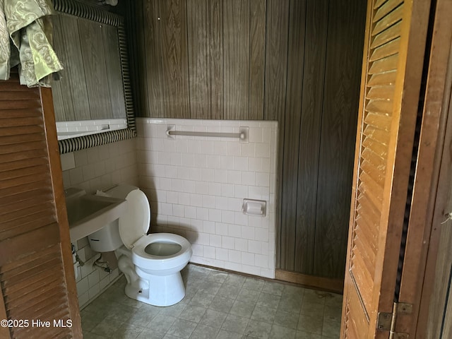 1207 Harrington St, Washington, NC 27889 - bathroom featuring toilet, tile walls, and wood walls