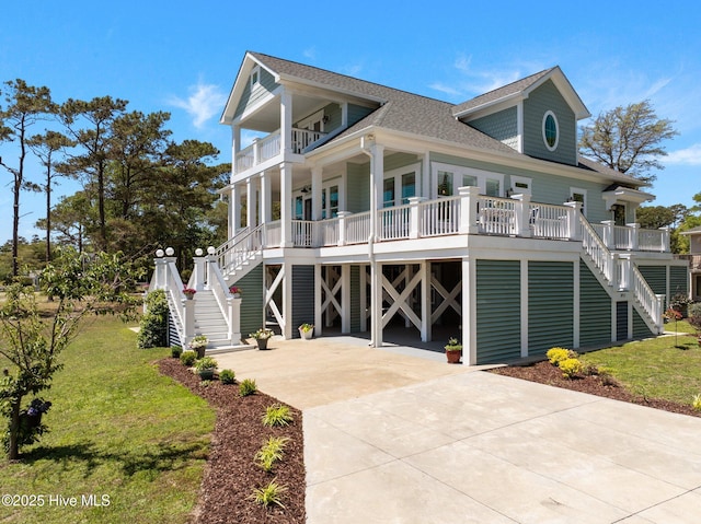 3953 Palm St SE, Bolivia, NC 28422 - coastal inspired home with stairway, a balcony, covered porch, and a shingled roof