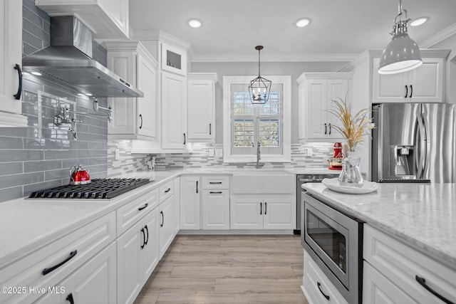 3953 Palm St SE, Bolivia, NC 28422 - kitchen featuring wall chimney range hood, appliances with stainless steel finishes, ornamental molding, white cabinets, and recessed lighting