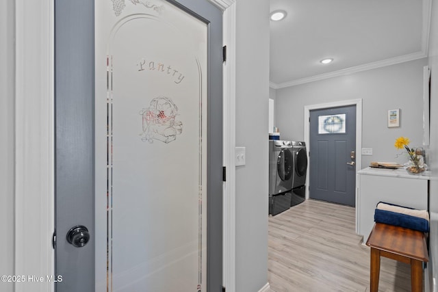 3953 Palm St SE, Bolivia, NC 28422 - washroom with washer and clothes dryer, crown molding, and light wood-type flooring