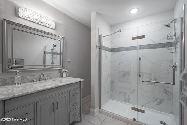 3953 Palm St SE, Bolivia, NC 28422 - bathroom with marble look tiles, a shower stall, vanity, and baseboards
