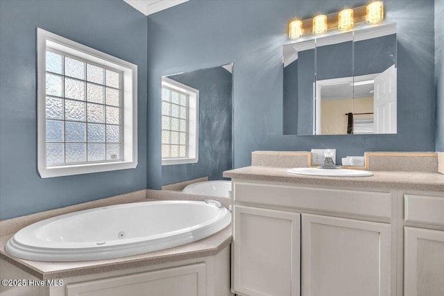 bathroom featuring a whirlpool tub and vanity