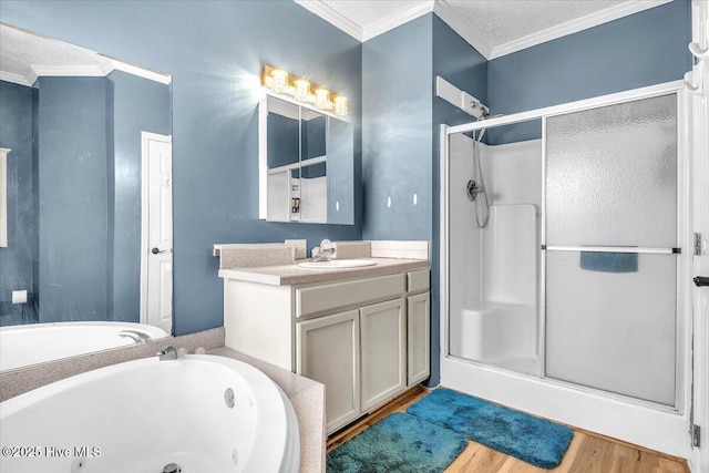 full bathroom featuring a jetted tub, crown molding, a shower stall, and wood finished floors