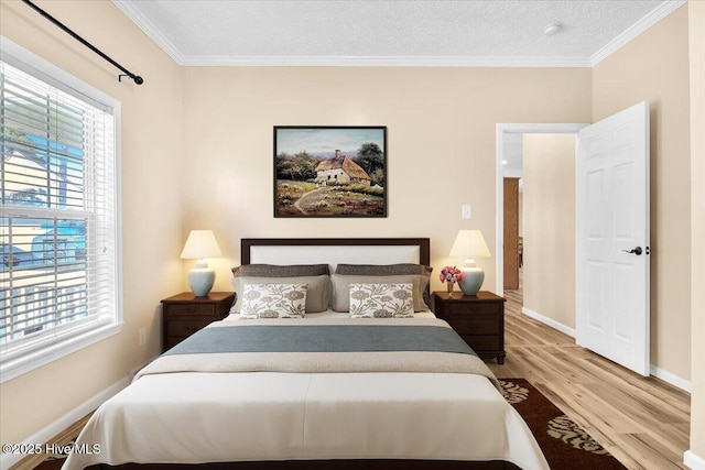 bedroom with baseboards, a textured ceiling, wood finished floors, and crown molding