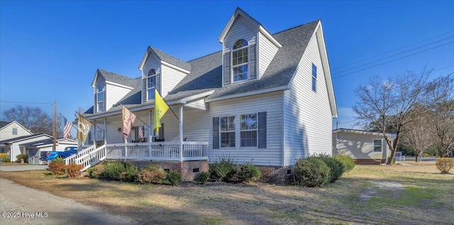 view of front of property featuring a porch and a shingled roof