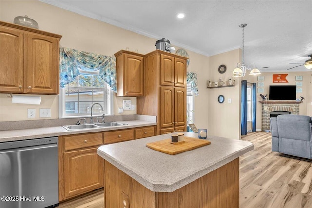 kitchen featuring a sink, open floor plan, light countertops, ornamental molding, and dishwasher