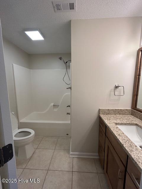 full bathroom featuring tile patterned flooring, toilet, shower / bathtub combination, a textured ceiling, and vanity