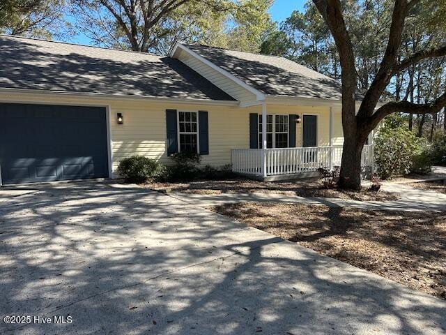 view of front of property featuring a garage and a porch