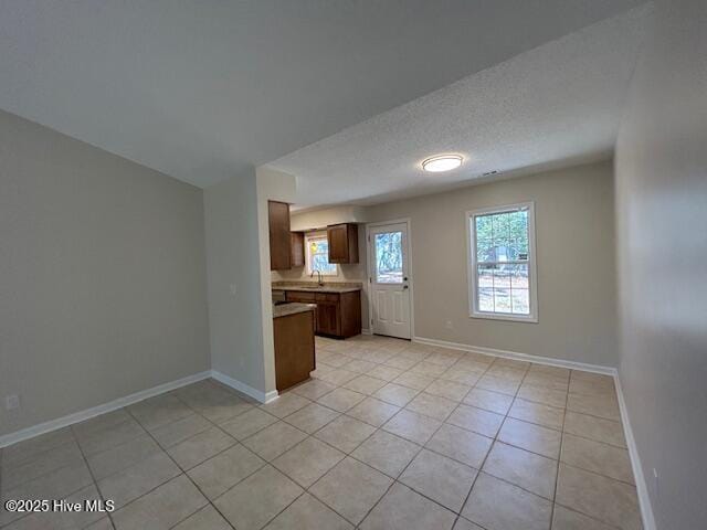 kitchen featuring light tile patterned floors and a textured ceiling