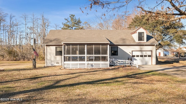 view of front of property with concrete driveway, an attached garage, a front yard, a sunroom, and crawl space