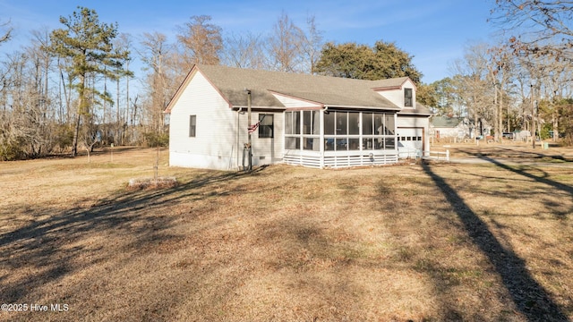 exterior space featuring crawl space, a sunroom, and a yard