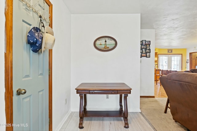 entryway with french doors, baseboards, and wood finished floors