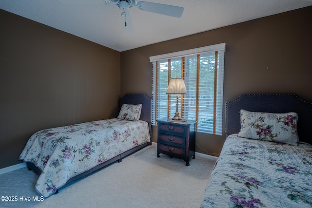 carpeted bedroom with baseboards and a ceiling fan