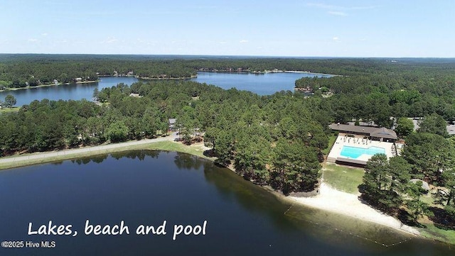 drone / aerial view with a view of trees and a water view