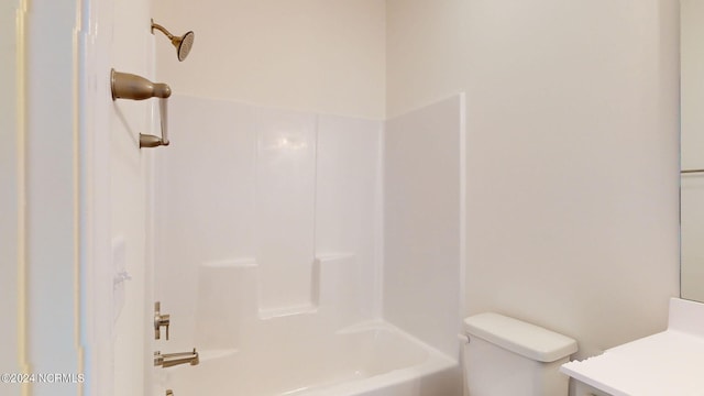 full bath with toilet, vanity, and bathing tub / shower combination