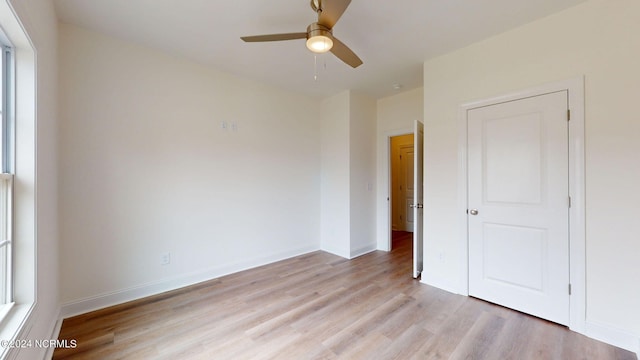 unfurnished bedroom featuring baseboards, ceiling fan, and light wood finished floors