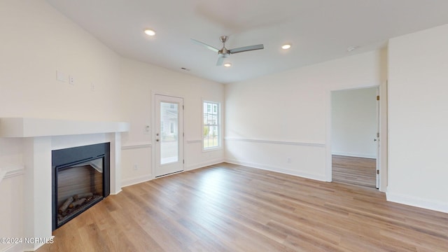 unfurnished living room featuring a ceiling fan, a glass covered fireplace, light wood-style flooring, and recessed lighting