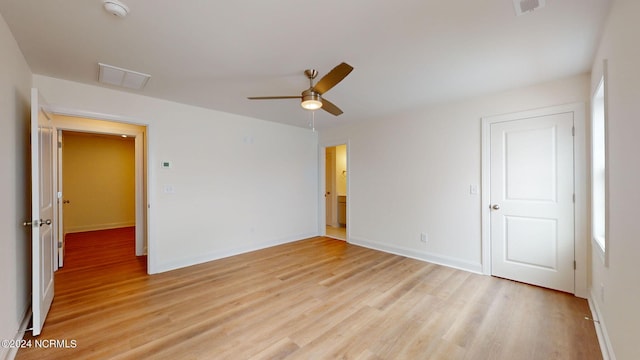 unfurnished room featuring visible vents, a ceiling fan, light wood-style flooring, and baseboards