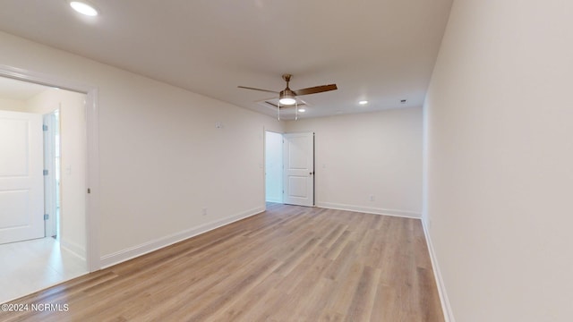 empty room with ceiling fan, recessed lighting, light wood-type flooring, and baseboards