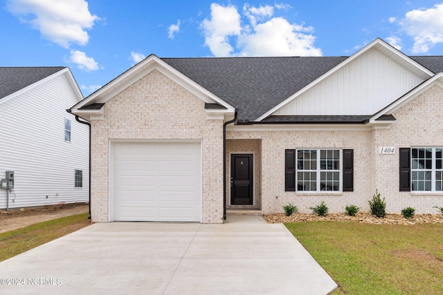 view of front of property featuring an attached garage, brick siding, driveway, roof with shingles, and a front lawn