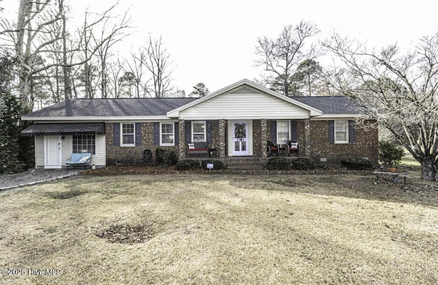 single story home with covered porch and a front yard