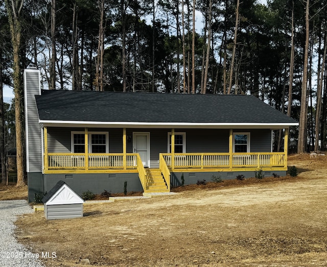 view of front of property with crawl space, a chimney, a porch, and roof with shingles