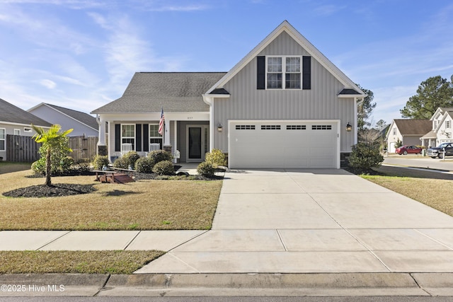 view of front of house featuring a garage, concrete driveway, a front lawn, and board and batten siding