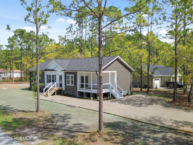 1601 Navajo Rd, Southport, NC 28461 - view of front facade featuring a porch, crawl space, and roof with shingles