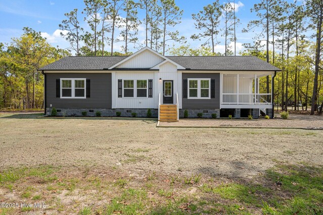 1601 Navajo Rd, Southport, NC 28461 - manufactured / mobile home featuring covered porch, crawl space, a shingled roof, and a front lawn