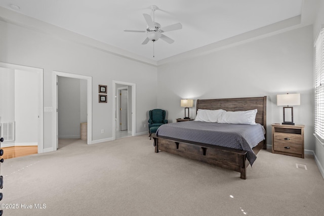 carpeted bedroom featuring a ceiling fan, visible vents, and baseboards