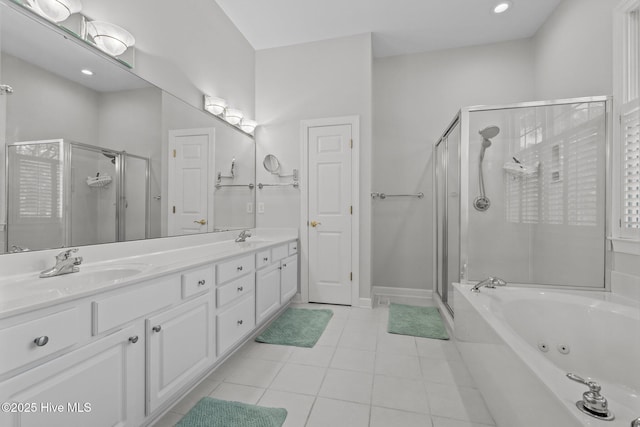 full bath featuring a stall shower, a sink, a tub with jets, tile patterned flooring, and double vanity