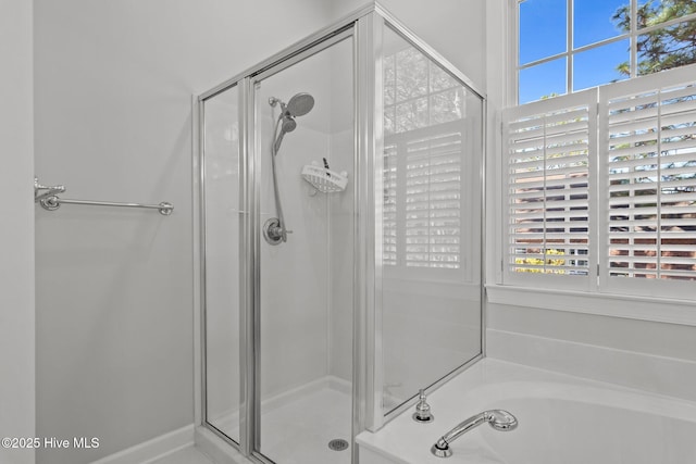 full bathroom featuring a shower stall and a garden tub