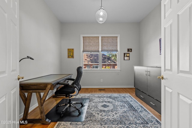 home office featuring light wood-style flooring and baseboards