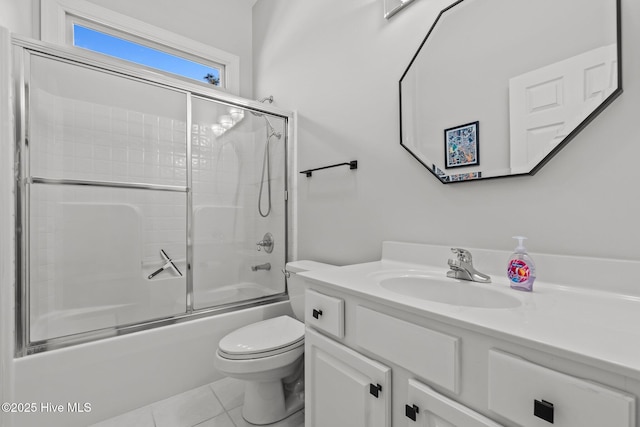 bathroom with tile patterned flooring, toilet, vanity, and enclosed tub / shower combo