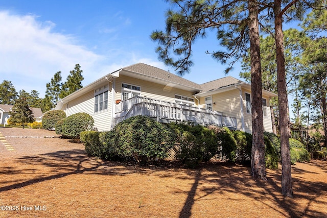 view of side of property featuring a wooden deck