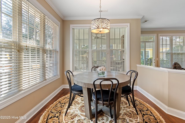 4155 Windham Ln, Southport, NC 28461 - dining area with dark wood finished floors, plenty of natural light, and crown molding