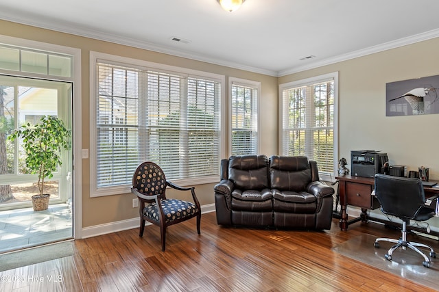 office area with wood finished floors, visible vents, ornamental molding, and baseboards