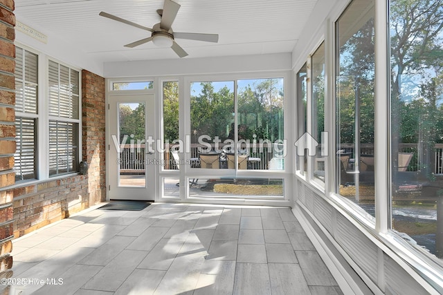 4155 Windham Ln, Southport, NC 28461 - unfurnished sunroom with a ceiling fan, tile patterned floors, and brick wall