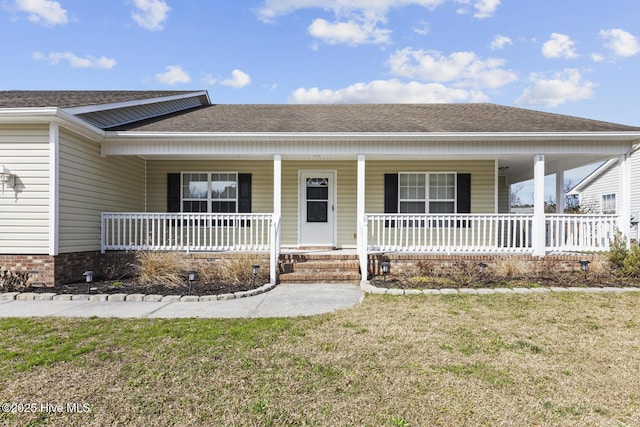 view of front facade with covered porch and a front yard