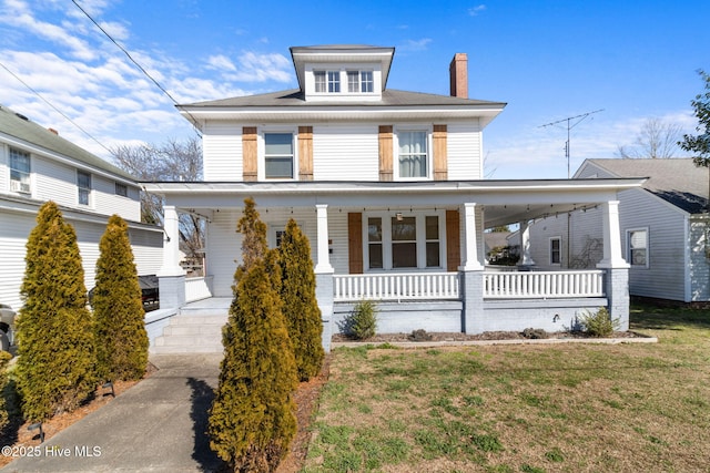 view of front of house featuring covered porch and a front yard