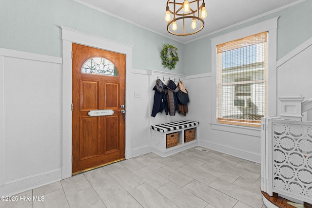 mudroom featuring ornamental molding, a chandelier, and light tile patterned floors